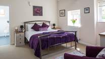 This is Bedroom 1, with its lofty beamed ceiling and king-size bed.