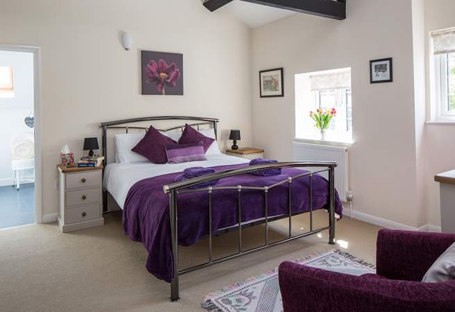 This is Bedroom 1, the master bedroom, with its lofty beamed ceiling and king-size bed.