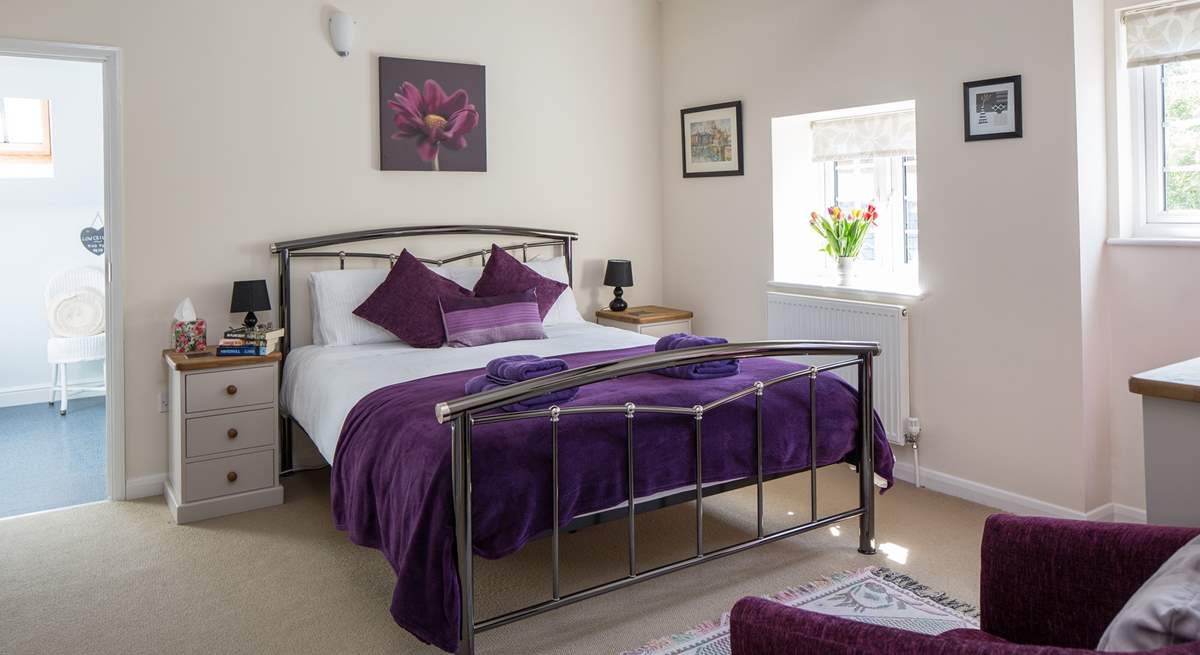 This is Bedroom 1, the master bedroom, with its lofty beamed ceiling and king-size bed.