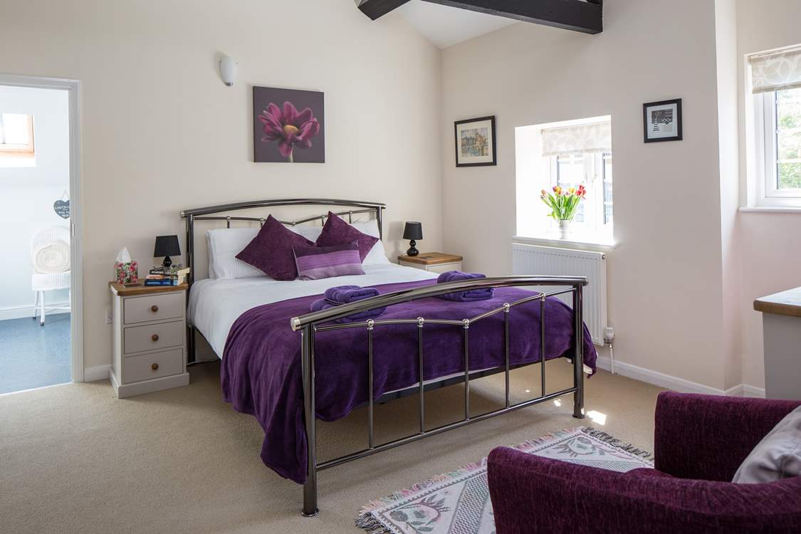 This is Bedroom 1, the master bedroom, with its lofty beamed ceiling and king-size bed.