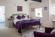 This is Bedroom 1, the master bedroom, with its lofty beamed ceiling and king-size bed.