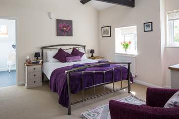 This is Bedroom 1, the master bedroom, with its lofty beamed ceiling and king-size bed.