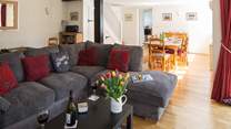 This sociable room has plenty of space for the L-shaped sofa, two armchairs, a play-area and the dining-area.