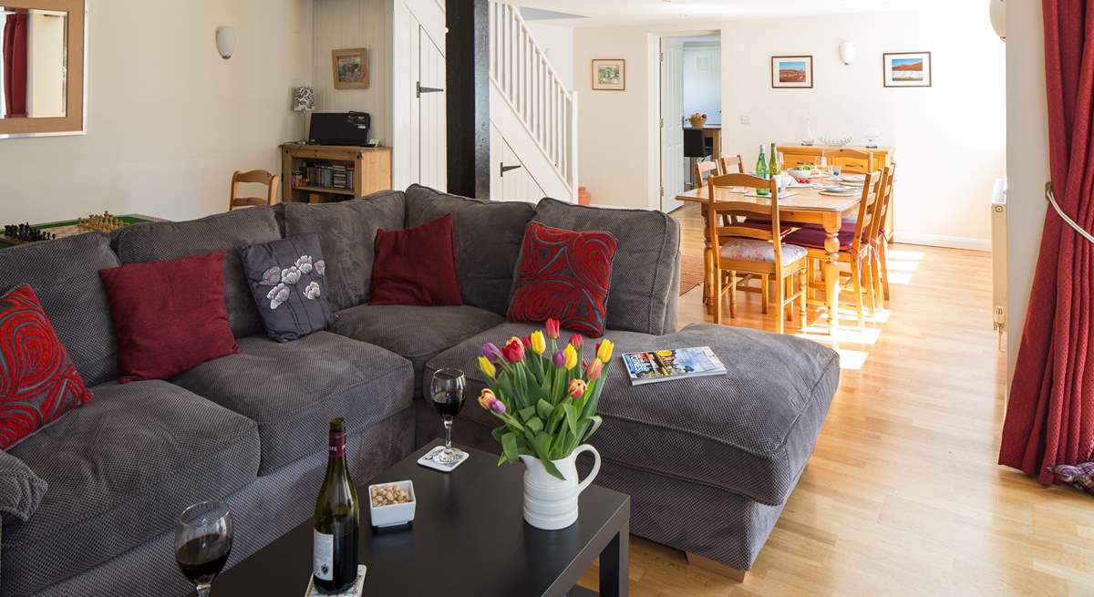 This sociable room has plenty of space for the L-shaped sofa, two armchairs, a play-area and the dining-area.