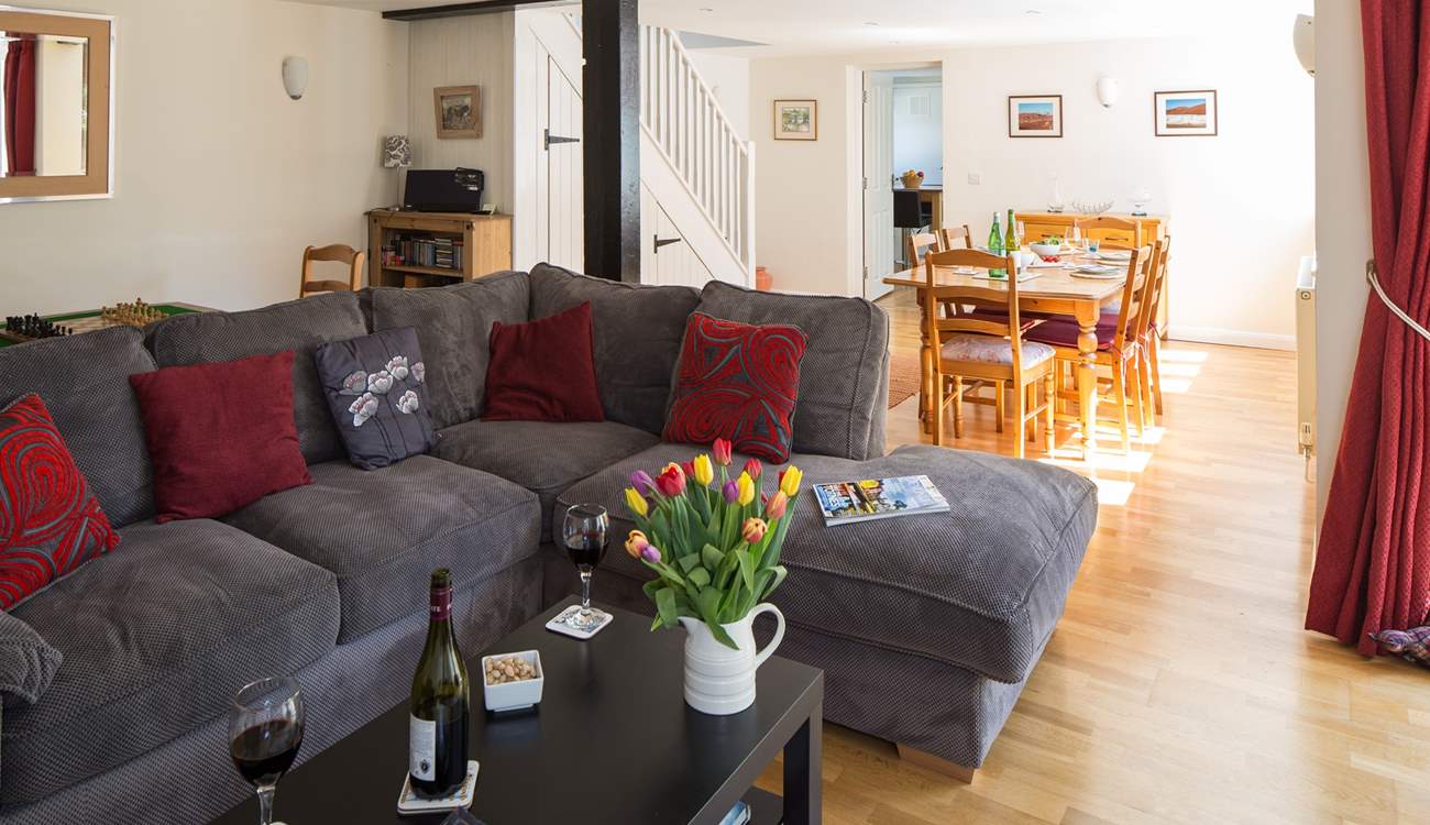 This sociable room has plenty of space for the L-shaped sofa, two armchairs, a play-area and the dining-area.