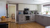The kitchen has a convenient free-standing table with bar type stools for any early risers.