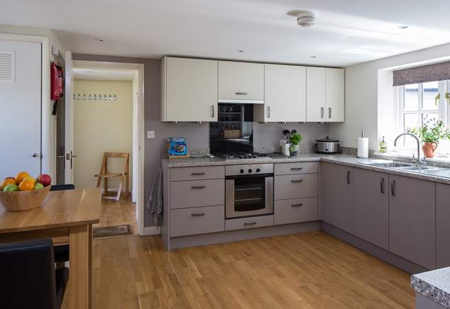 The kitchen has a convenient free-standing table with bar type stools for any early risers.