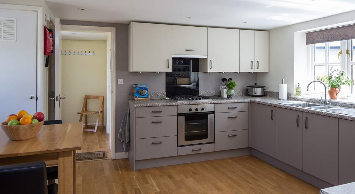 The kitchen has a convenient free-standing table with bar type stools for any early risers.