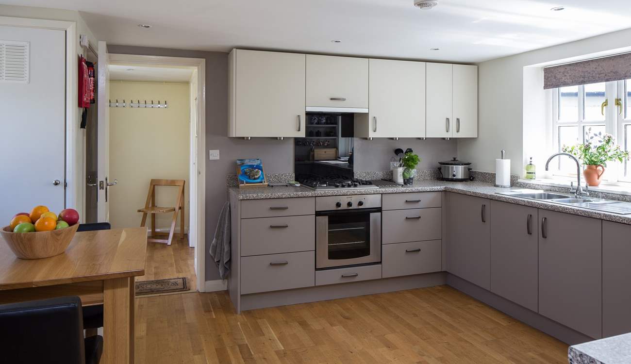 The kitchen has a convenient free-standing table with bar type stools for any early risers.