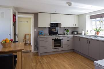 The kitchen has a convenient free-standing table with bar type stools for any early risers.