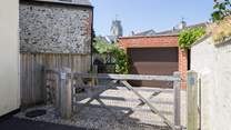 There is one parking space through the gate in front of the garage, the other is this side of the gate.