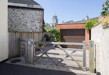 There is one parking space through the gate in front of the garage, the other is this side of the gate.