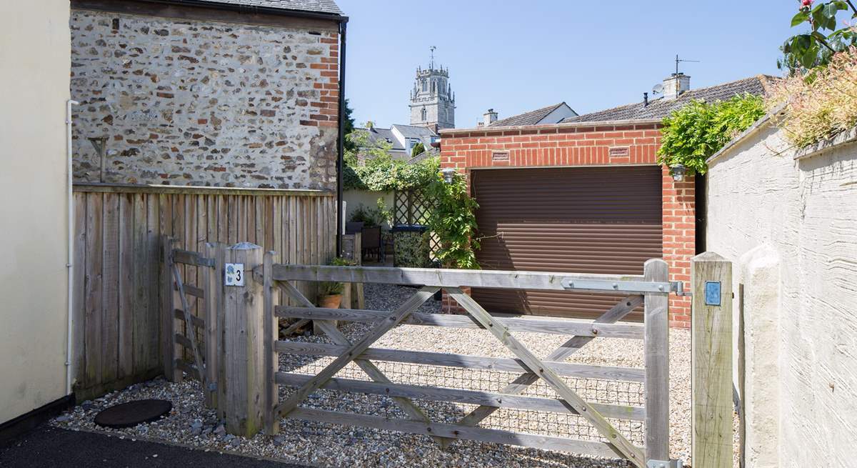 There is one parking space through the gate in front of the garage, the other is this side of the gate.