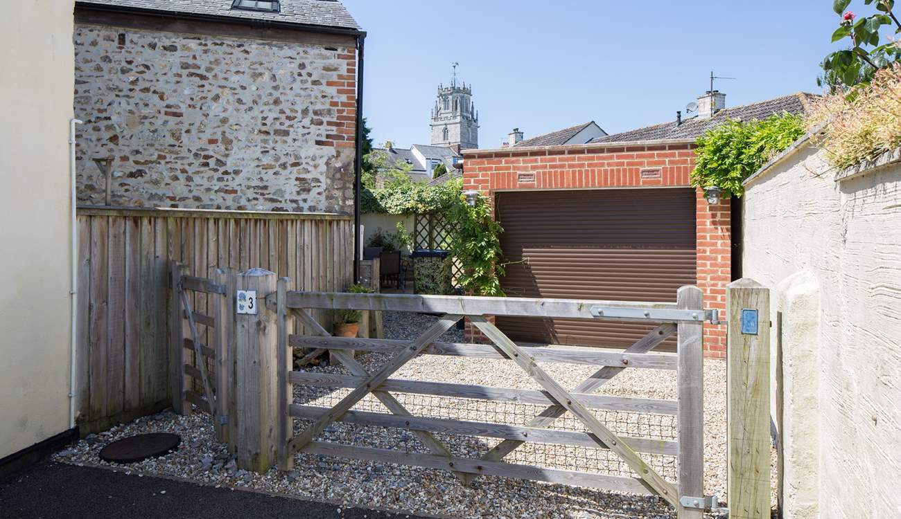 There is one parking space through the gate in front of the garage, the other is this side of the gate.