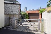 There is one parking space through the gate in front of the garage, the other is this side of the gate.