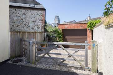 There is one parking space through the gate in front of the garage, the other is this side of the gate.