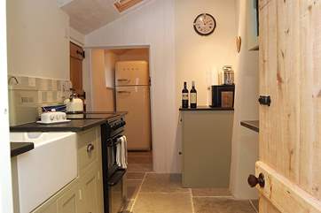 A well-designed kitchen makes the most of the space with a walk-in larder at the far end.