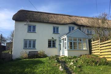 Kentisbury Cottage has an enclosed garden with a wooden fence on one side and a bank and hedging to the other. The garden seating and barbecue are at the bottom end of the garden.