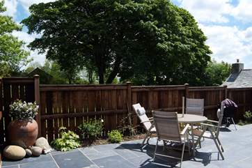 The enclosed patio behind the cottage is a lovely spot to sit out and enjoy the Cornish sunshine.