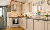 The stylish kitchen is well-equipped. - Thumbnail Image