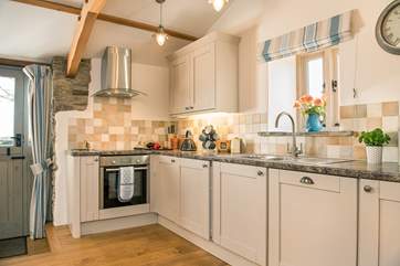 The stylish kitchen is well-equipped.