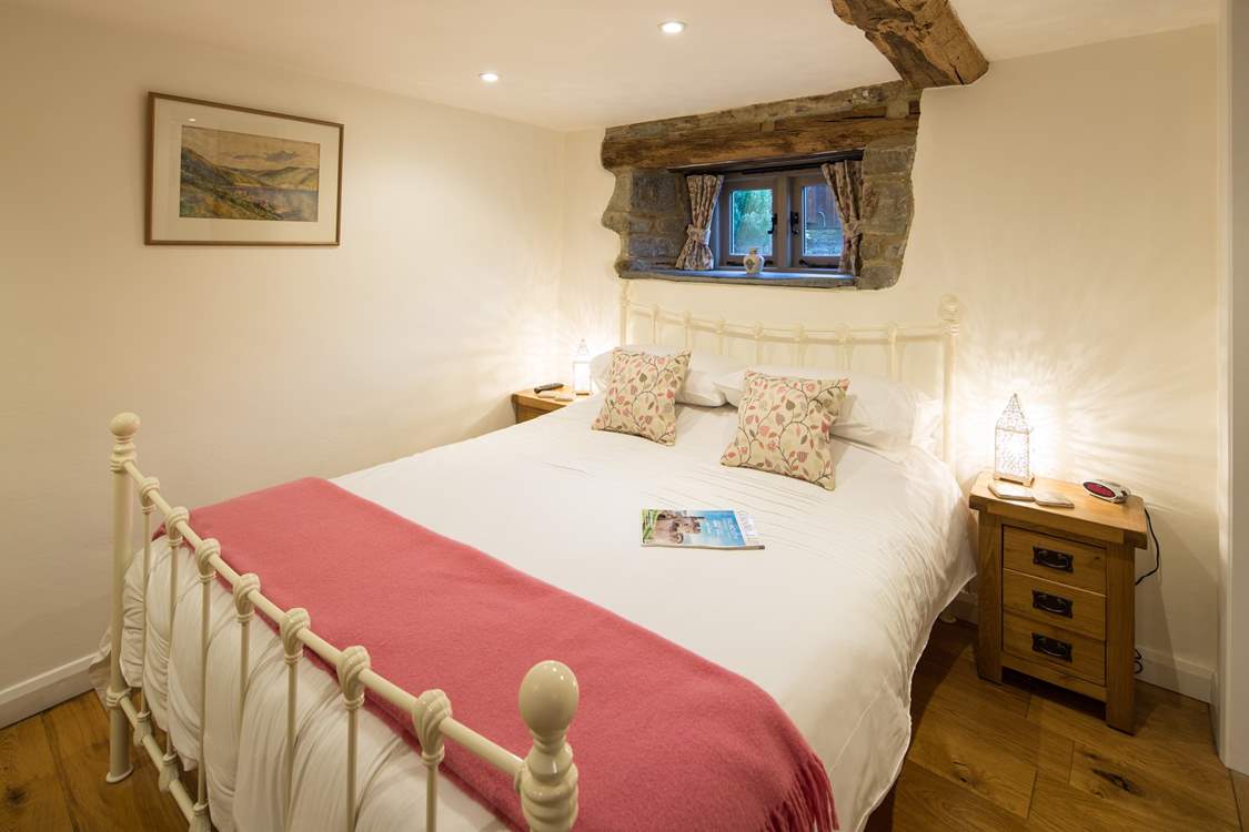 Bedroom 1 has a lovely brass bed.