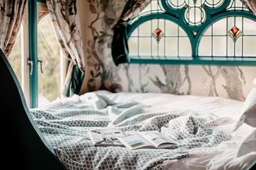 The sumptuous king-sized bed boasts idyllic views of Branscombe Valley.