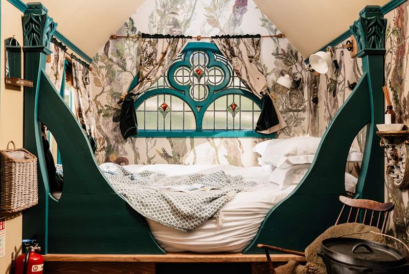From its gorgeous woodland wallpaper to the pretty stained glass window, this hideaway is full of character.