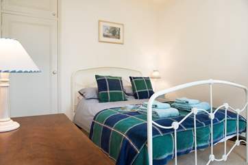 This bedroom has a lovely bedstead, and enjoys views over the front garden.
