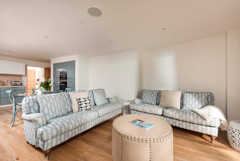 The open plan living area has patio doors which lead out onto the balcony with sea views.