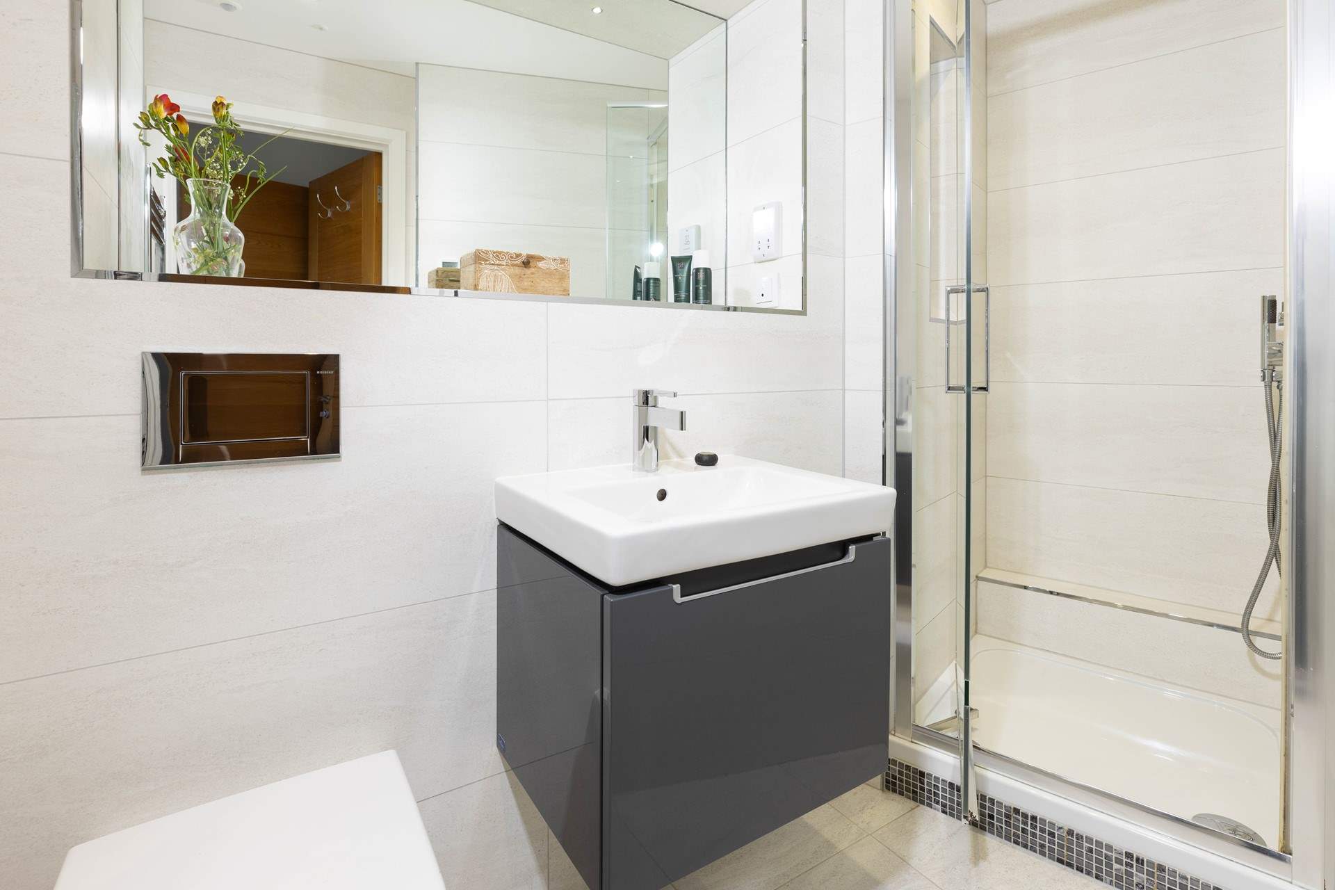 The modern en suite for bedroom 1 complete with power shower.