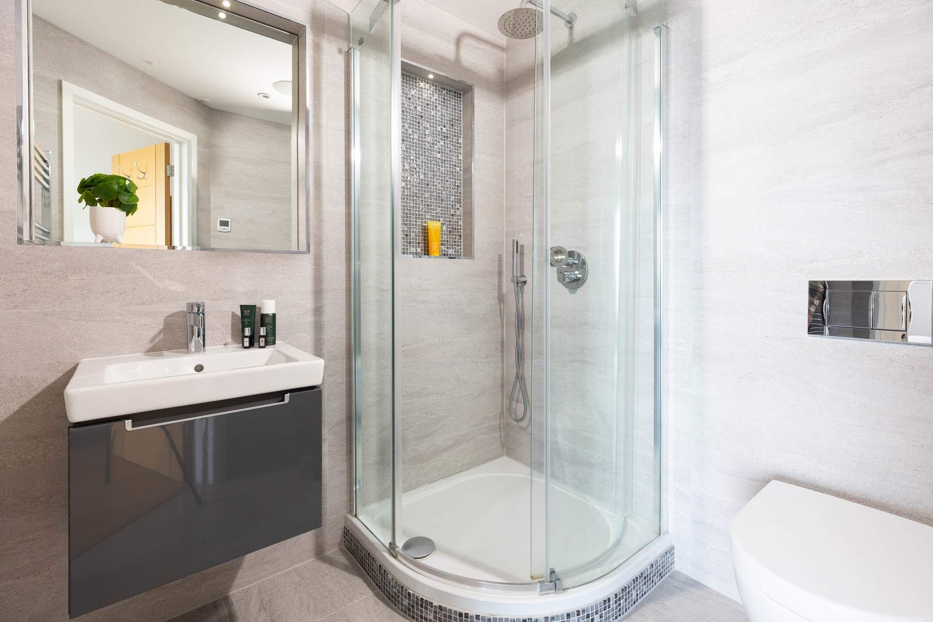 Floor to ceiling tiling in this impeccable en suite.