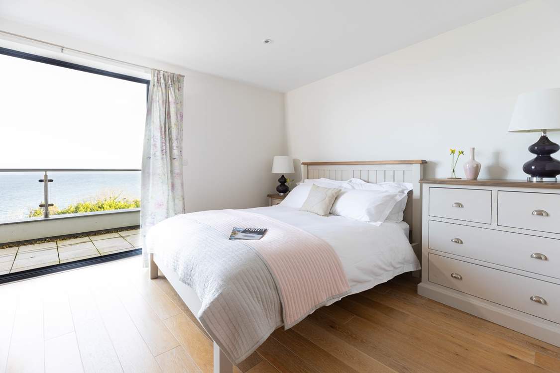 Throw open the doors in bedroom 1 and let the sea air inside.