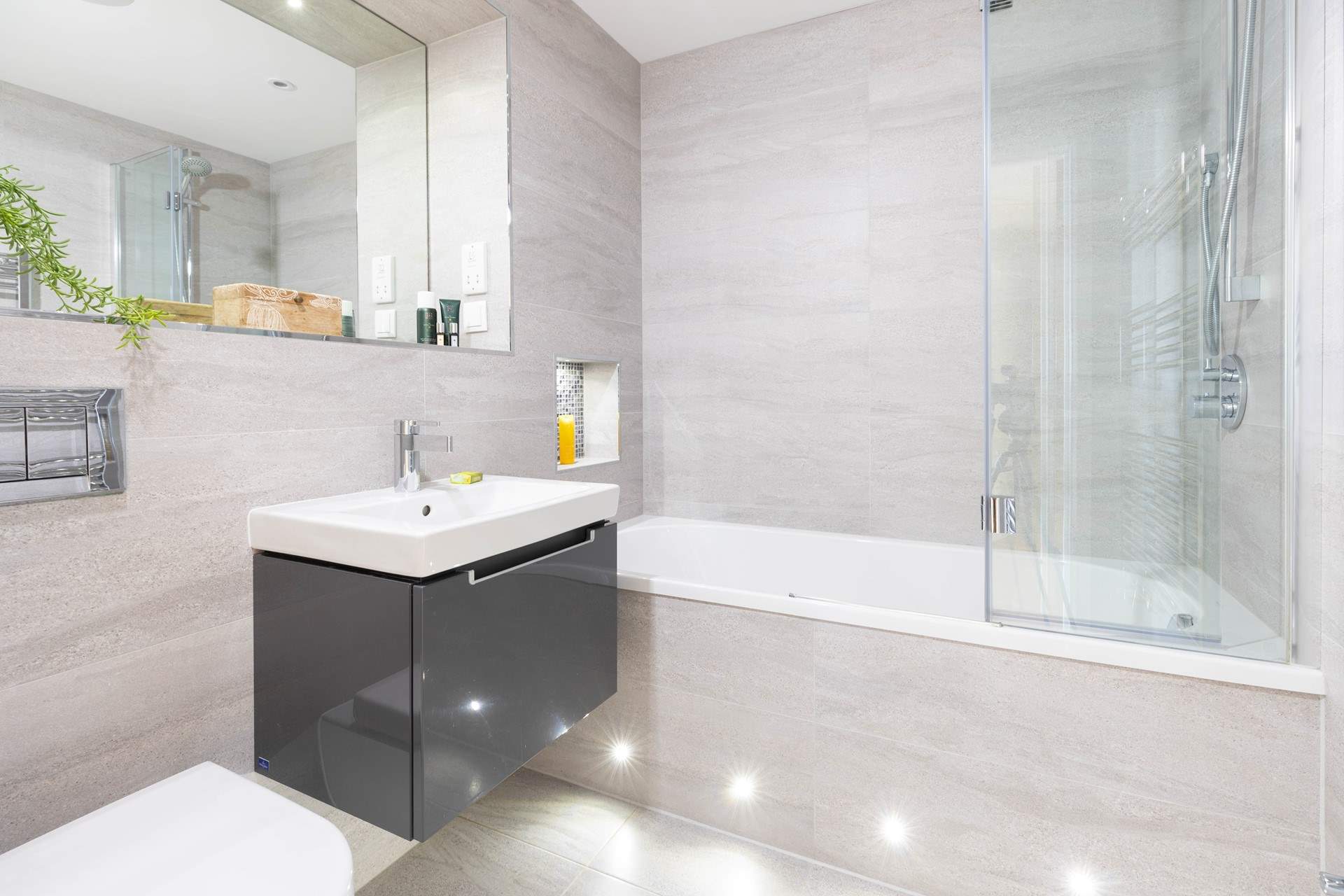 Mood lighting complements both the family bathroom and en suite shower-room.