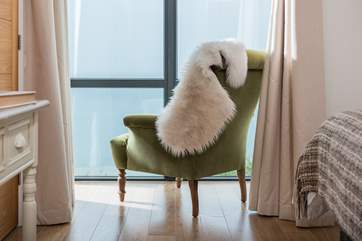 The squidgy armchair perfectly positioned in the main bedroom to curl up and watch the world sail by.