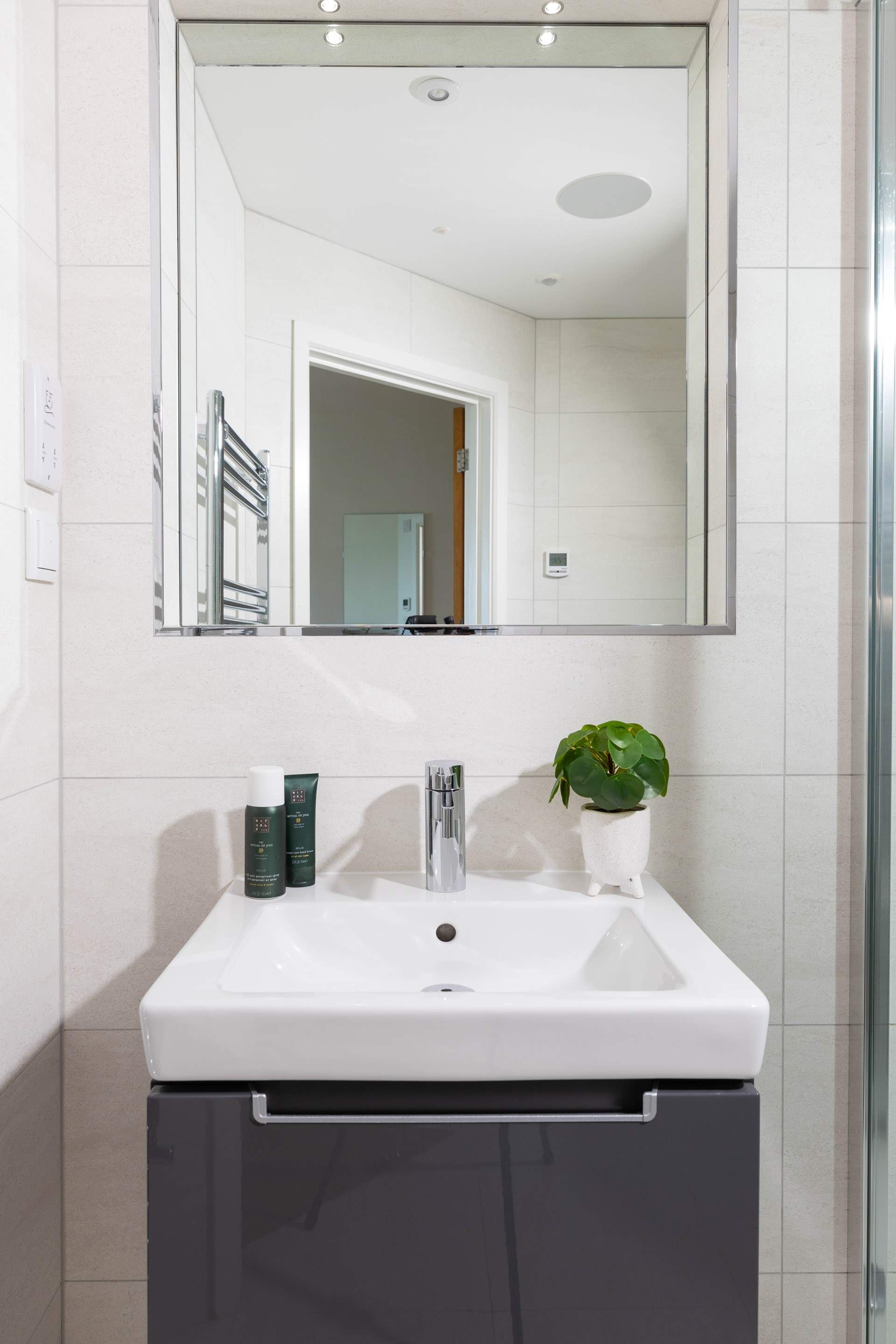  Both bath/shower-rooms are sleek and functional with minimalist design.