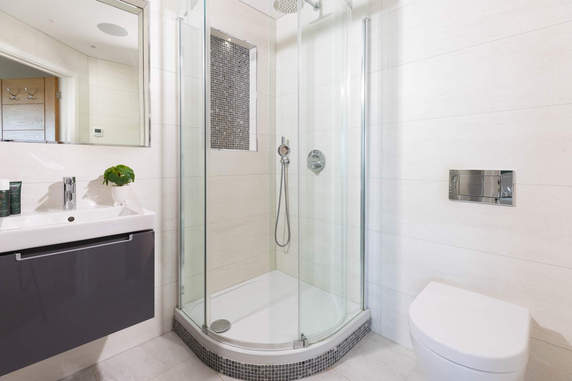 Bedroom 1 has a gorgeous en suite complete with power shower and modern lighting.