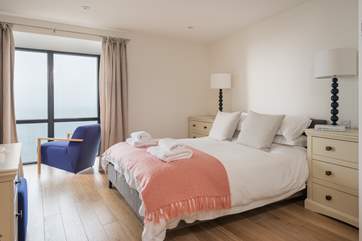 The soft pastel colours complement the main bedroom perfectly.