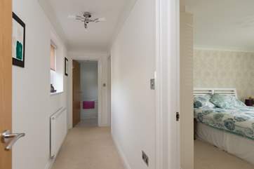 A short corridor links the two bedrooms and the bathroom.