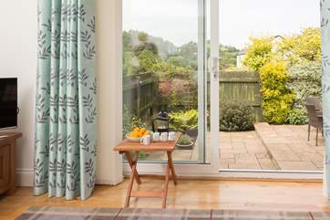The French doors open up, with two steps down to the garden.