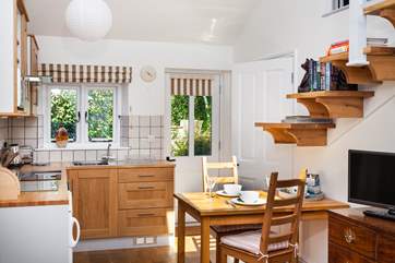 The lovely kitchen is bright and sunny.