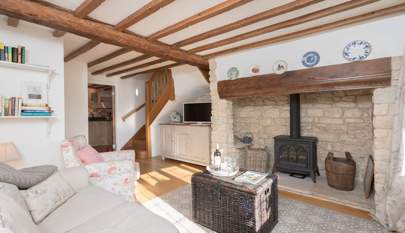 Stairs to the first floor lead up from the corner of the sitting-room.