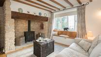The characterful sitting-room has a wood-burner effect gas stove for extra warmth.