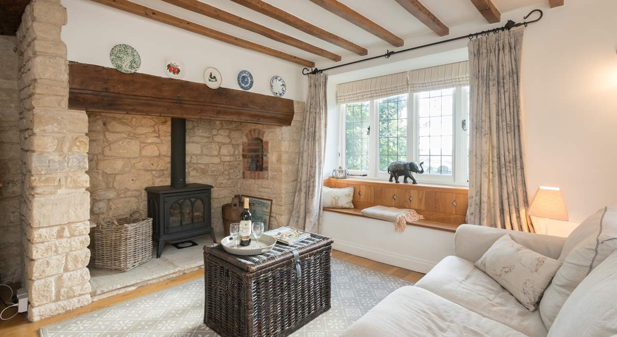 The characterful sitting-room has a wood-burner effect gas stove for extra warmth.