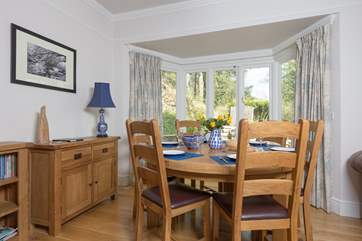 The dining-table has pride of place looking out over the terrace. The French windows open up to bring the outside in on a warm day.