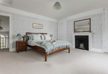 The exceptionally spacious main bedroom has dual-aspect windows overlooking the river Barle.