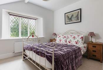There is also a double bedroom with a view out over the terrace and the wooded hillside.