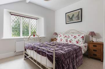 There is also a double bedroom with a view out over the terrace and the wooded hillside.
