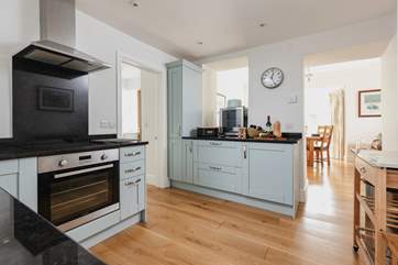 A contemporary kitchen makes use of some original features to link into the rest of the living-space.