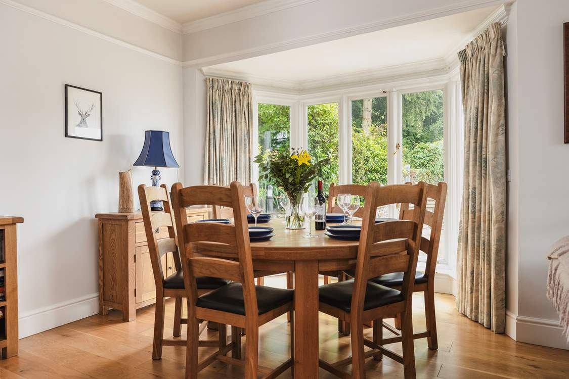 The dining-table has pride of place looking out over the terrace. The French windows open  up to bring the outside in on a warm day.